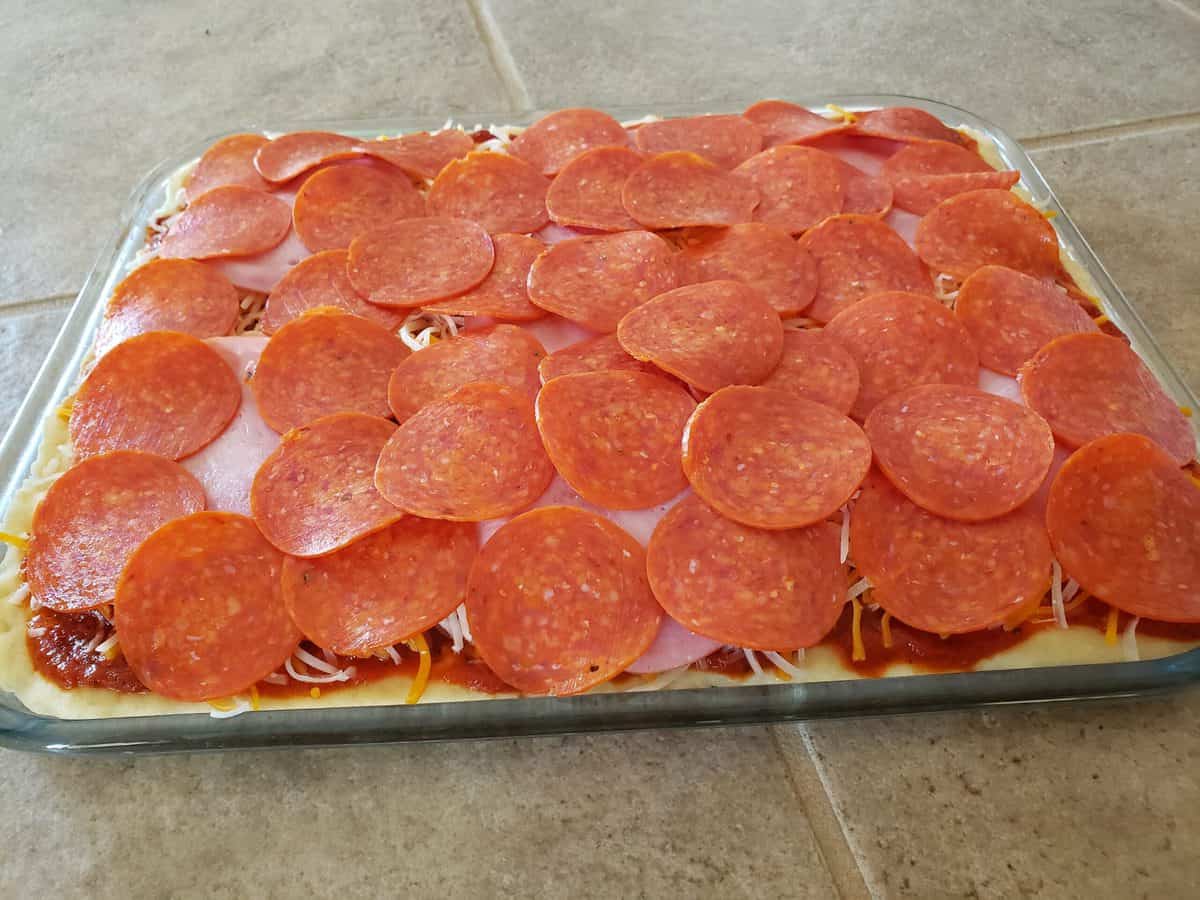 Add the pepperoni to the pizza.