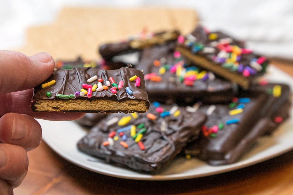 Chocolate covered graham crackers on a plate.