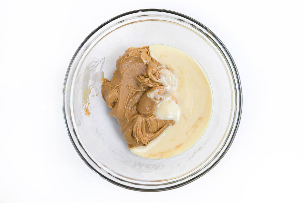 Sweetened condensed milk and creamy peanut in a bowl.