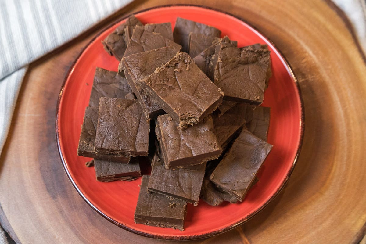 Peanut butter fudge cut into squares on a plate.