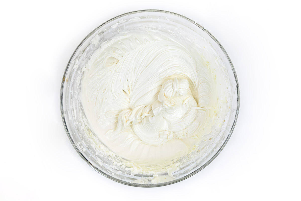 The vanilla extract is mixed together with the white chocolate buttercream frosting.
