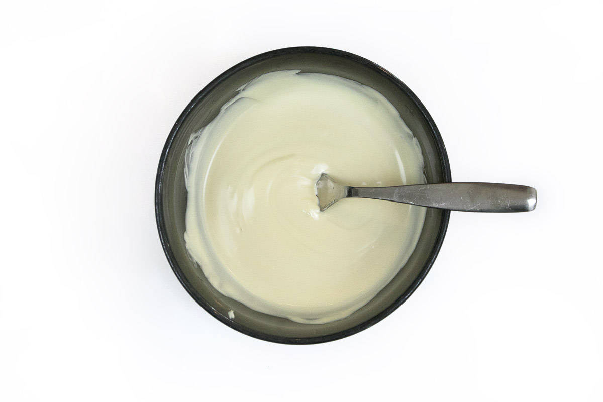 Melted white chocolate in a bowl.