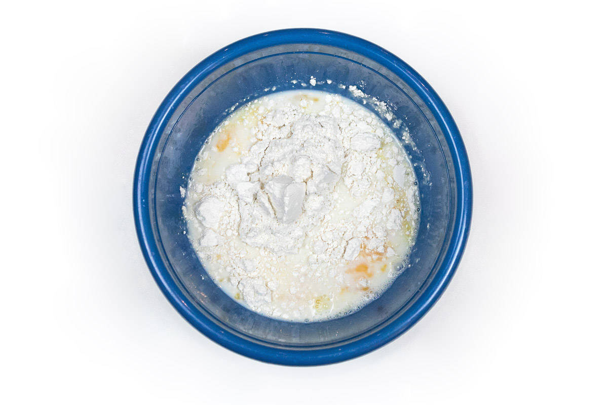 Bisquick mix, milk, and eggs in a bowl.