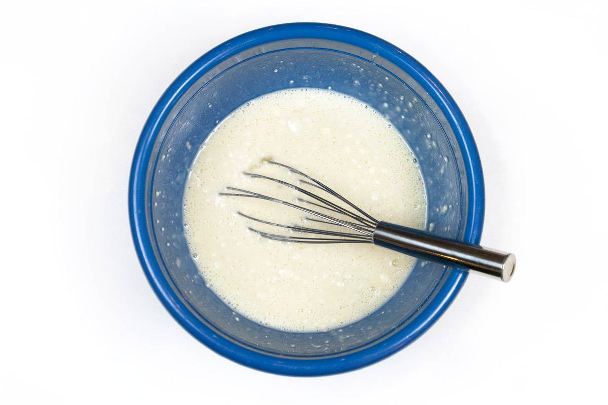 The Bisquick mix is blended together with the milk and eggs in the bowl.