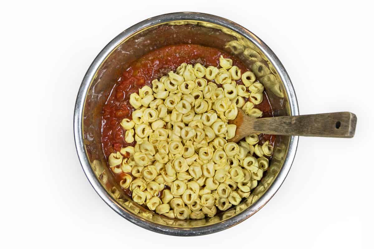 Three cheese tortellini pasta, browned ground beef, pasta sauce, and diced tomatoes.
