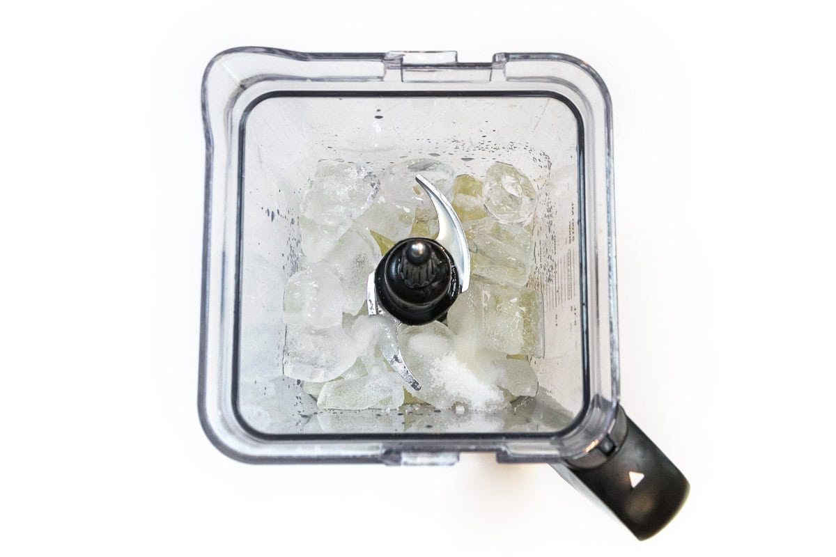 Lemon juice is added to the ice cubes and sugar.