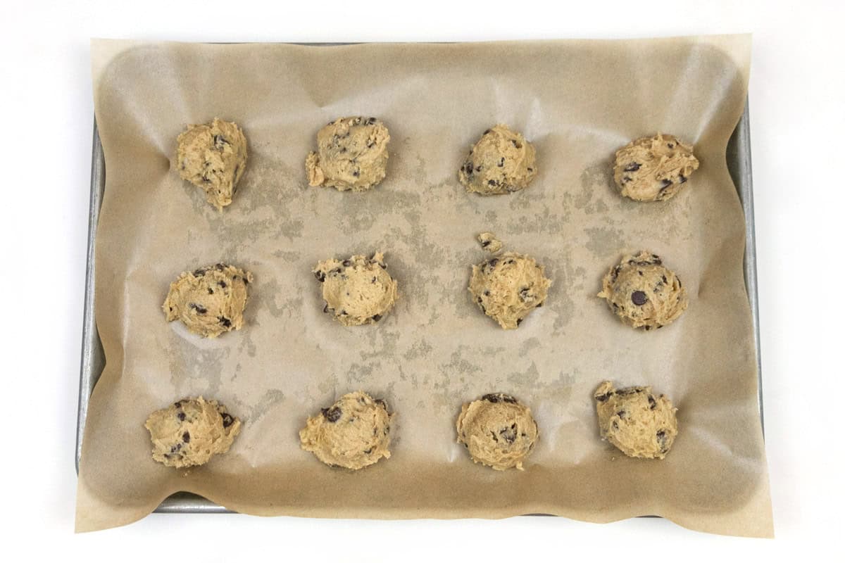 Cookie dough balls on the baking sheet.
