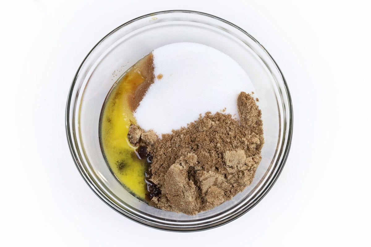 Butter, vanilla extract, granulated sugar, and brown sugar in a bowl.