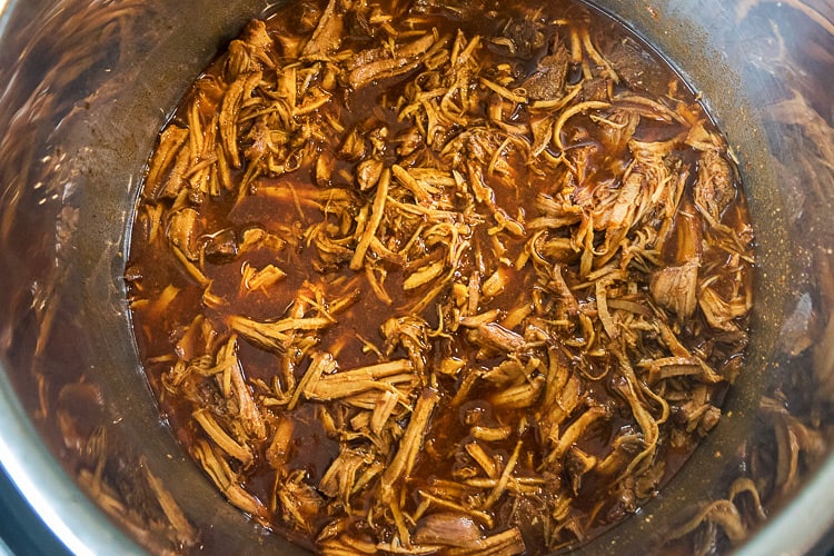 Pork is pulled apart with a fork.