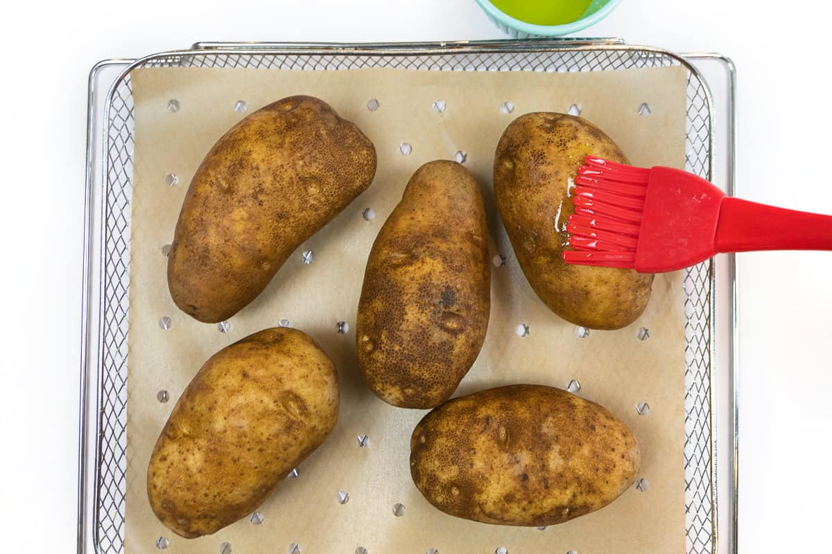 Brush the potatoes with olive oil.