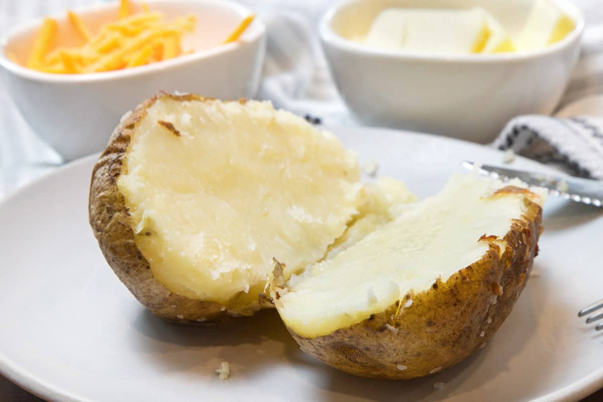 Air fryer baked potatoes on a plate.