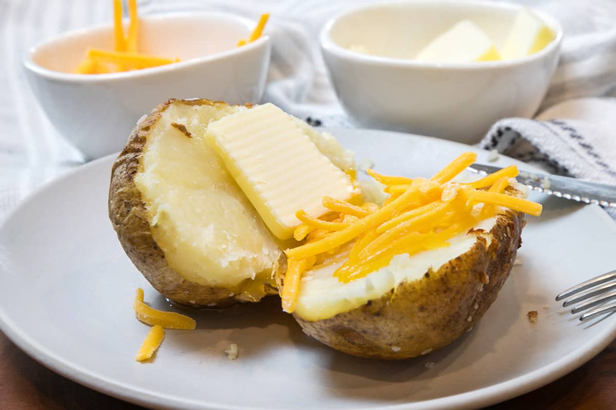 Air fryer baked potatoes on a plate.