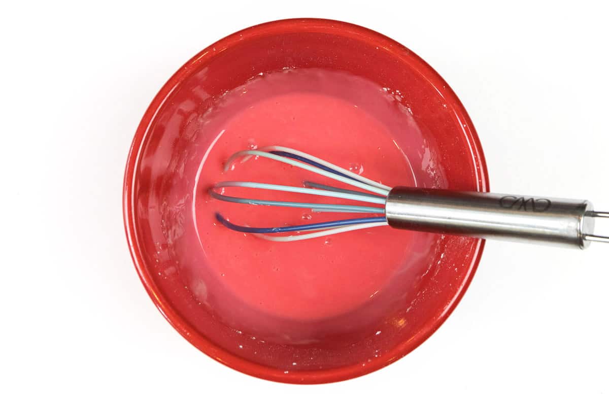 Mix the food coloring together with the powdered sugar, milk, and vanilla extract.