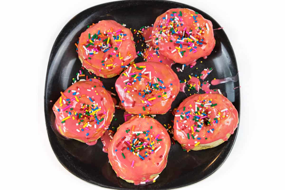 Sprinkles are added on top of the powdered sugar icing.