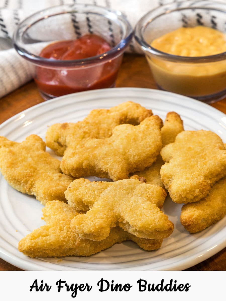 Eight air fryer Dino nuggets on a plate.