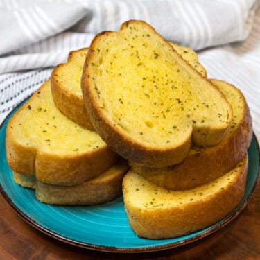 Frozen garlic bread recipe in the air fryer on a plate.