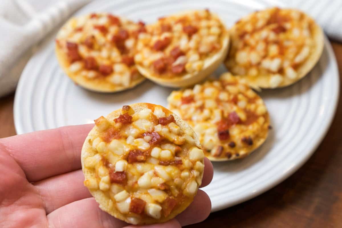 Air fryer frozen mini pizza bagels on a plate.
