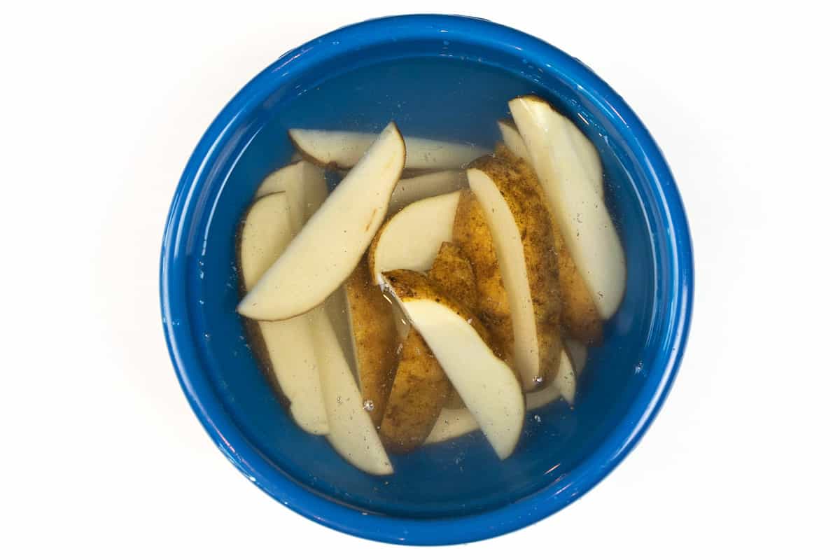 Place the potatoes in a bowl of cold water to soak for thirty minutes.