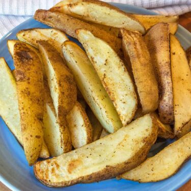 Air fryer potato wedges recipe on a plate.