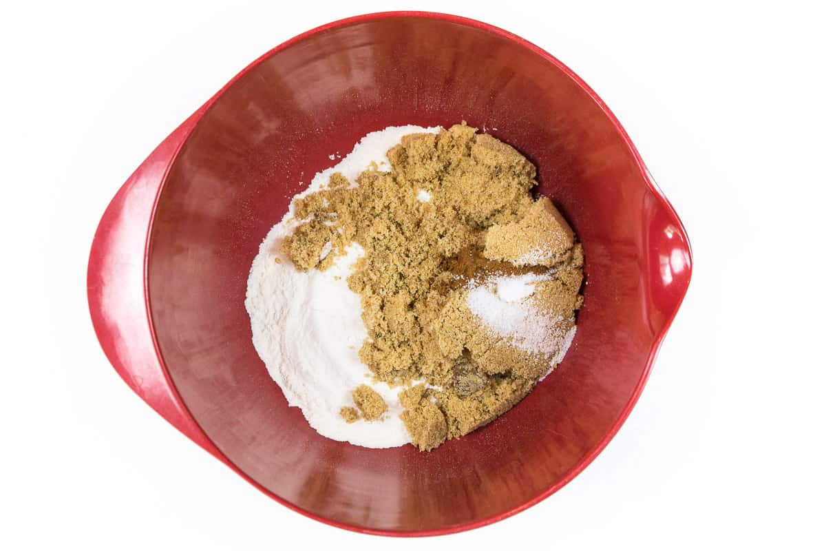 For the topping, add three-fourths cup of flour with three-fourths cup of golden brown sugar, one-half teaspoon of salt, and one-fourth teaspoon of cinnamon. Mix well.