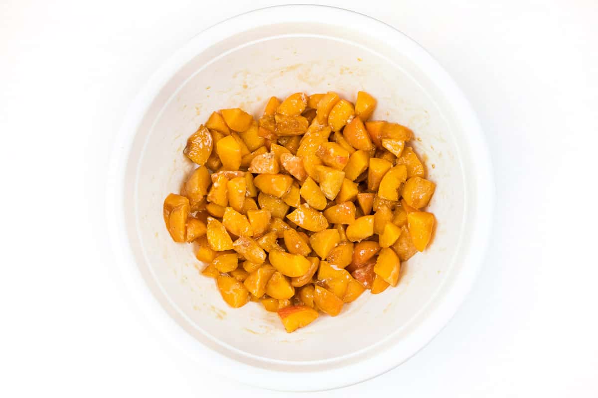 Mix the lemon juice, vanilla extract, all-purpose flour, and granulated sugar with the cut-up apricots.