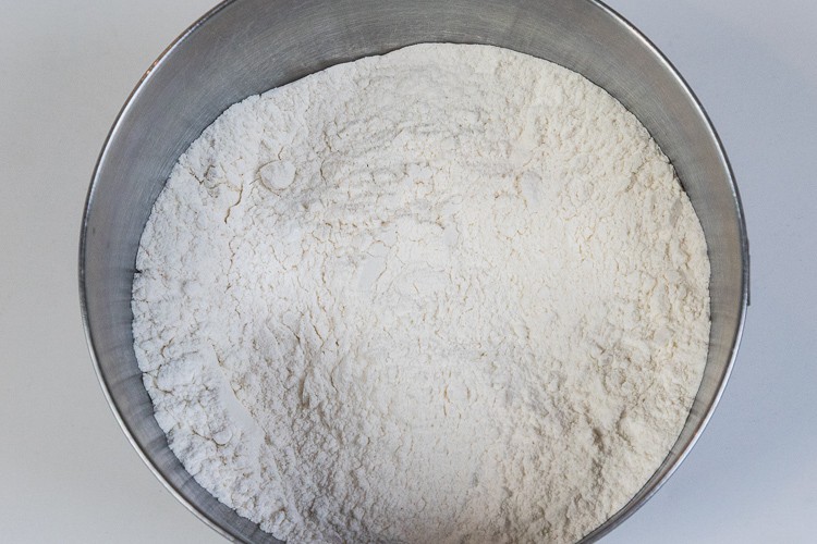 Flour, salt, baking powder, and baking soda in a bowl.
