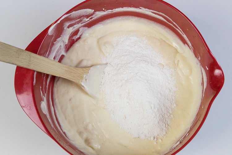 Slowly add the flour mixture to the banana bread mixture.