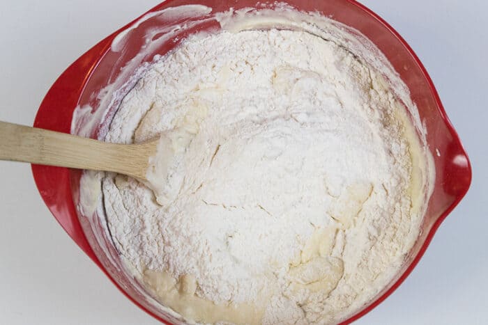 More of the flour mixture is added to the banana bread mixture.