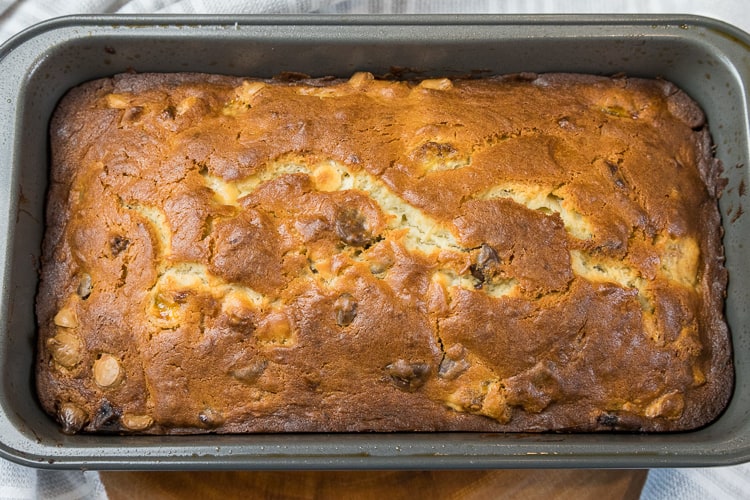 Banana bread with cream cheese and chocolate chips baked in a loaf pan.