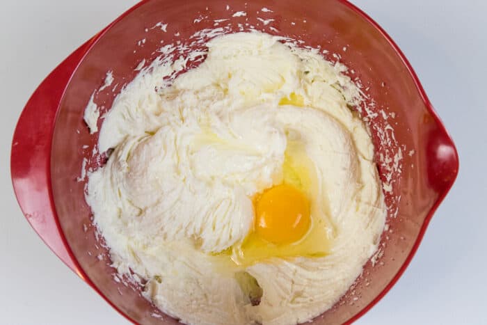 One egg has been added to the melted butter, cream cheese, and sugar.