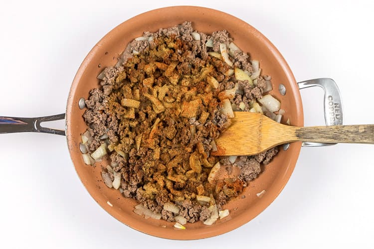 Add the cumin, cayenne pepper, and paprika to the ground beef mixture.
