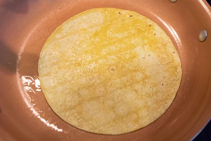 One tablespoon of olive oil in the frying pan on medium heat and fry a tortilla for 15 seconds on each side.