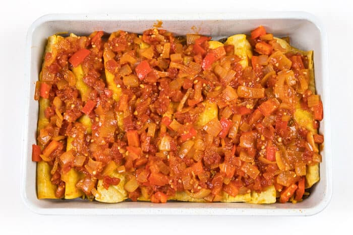 Put the onion mixture over the top of the beef enchiladas in the baking dish.