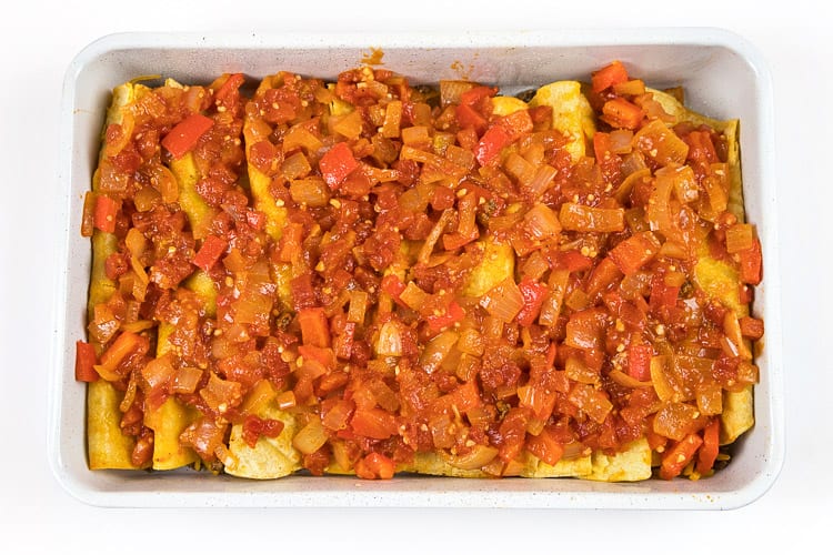 Put the onion mixture over the top of the beef enchiladas in the baking dish.