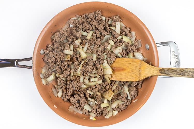 Add the ground beef in with the onion and cook on medium-high heat until there is no pink in the ground beef.