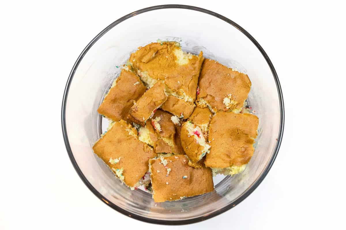 Place one-third of the squares of cake around the bottom of the bowl.