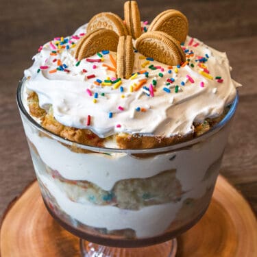 Birthday trifle cake with cookies recipe close up on a wooden platform.