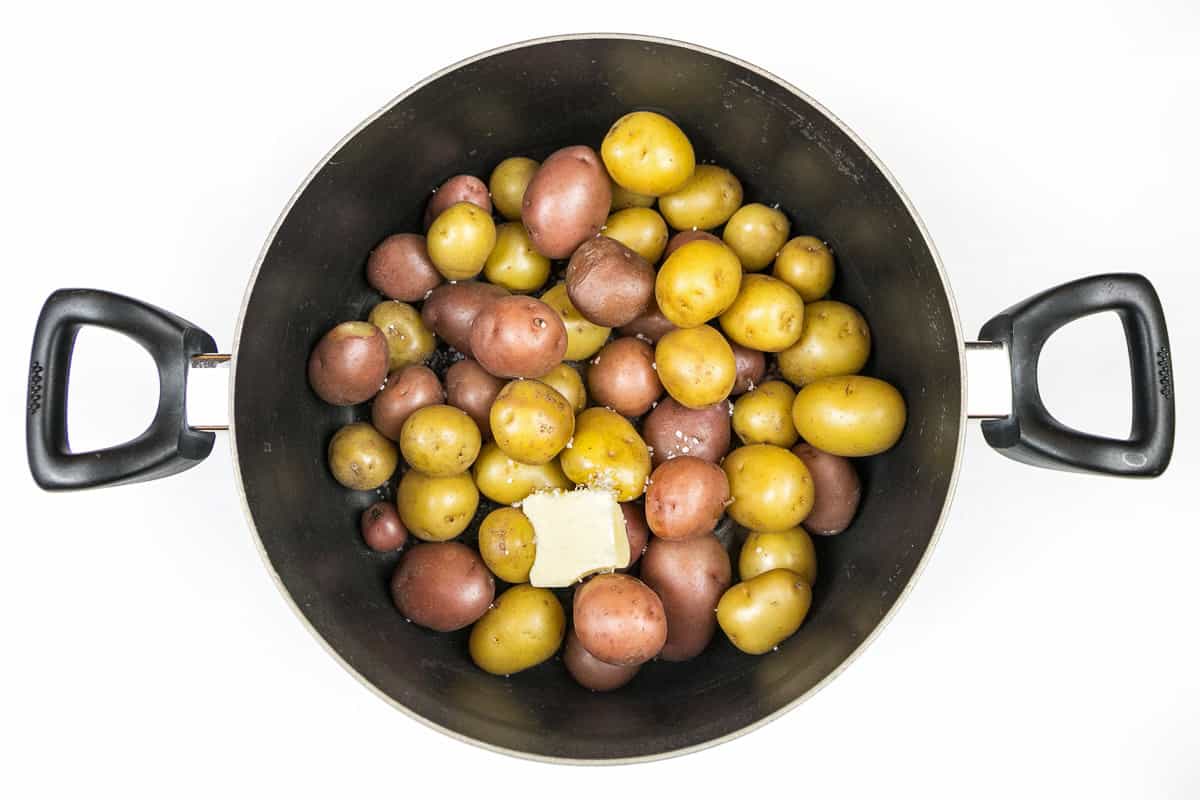 Butter and Kosher salt are added to the potatoes.