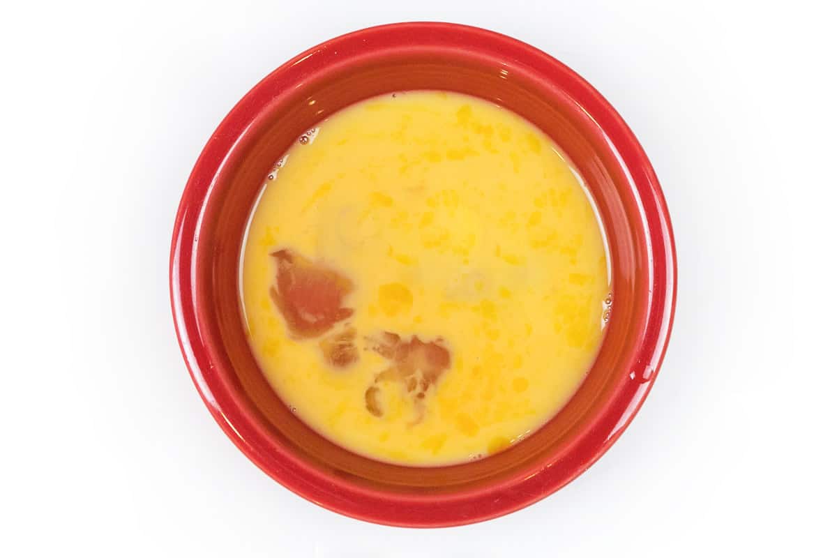 Beaten eggs in a bowl.
