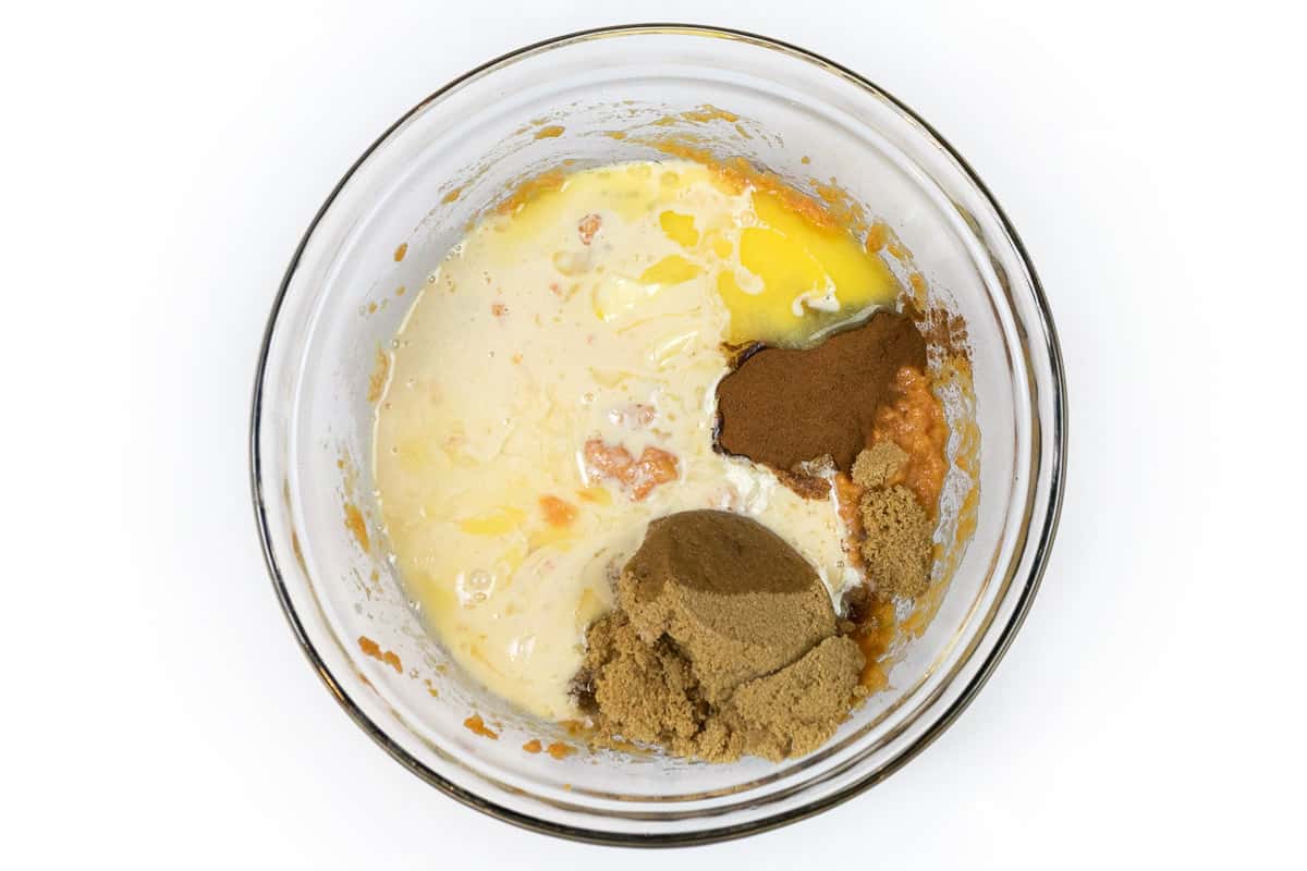 Melted butter, evaporated milk, lemon juice, ground cinnamon, and light brown sugar in a bowl.
