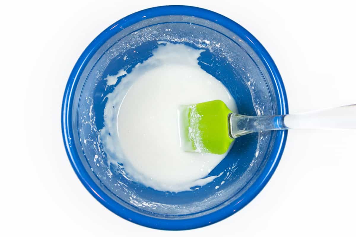 Powdered sugar and milk in a bowl.