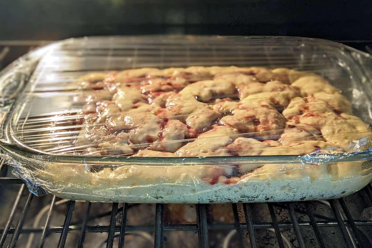 Baking dish wrapped with plastic wrap and put in a warm place to rise.