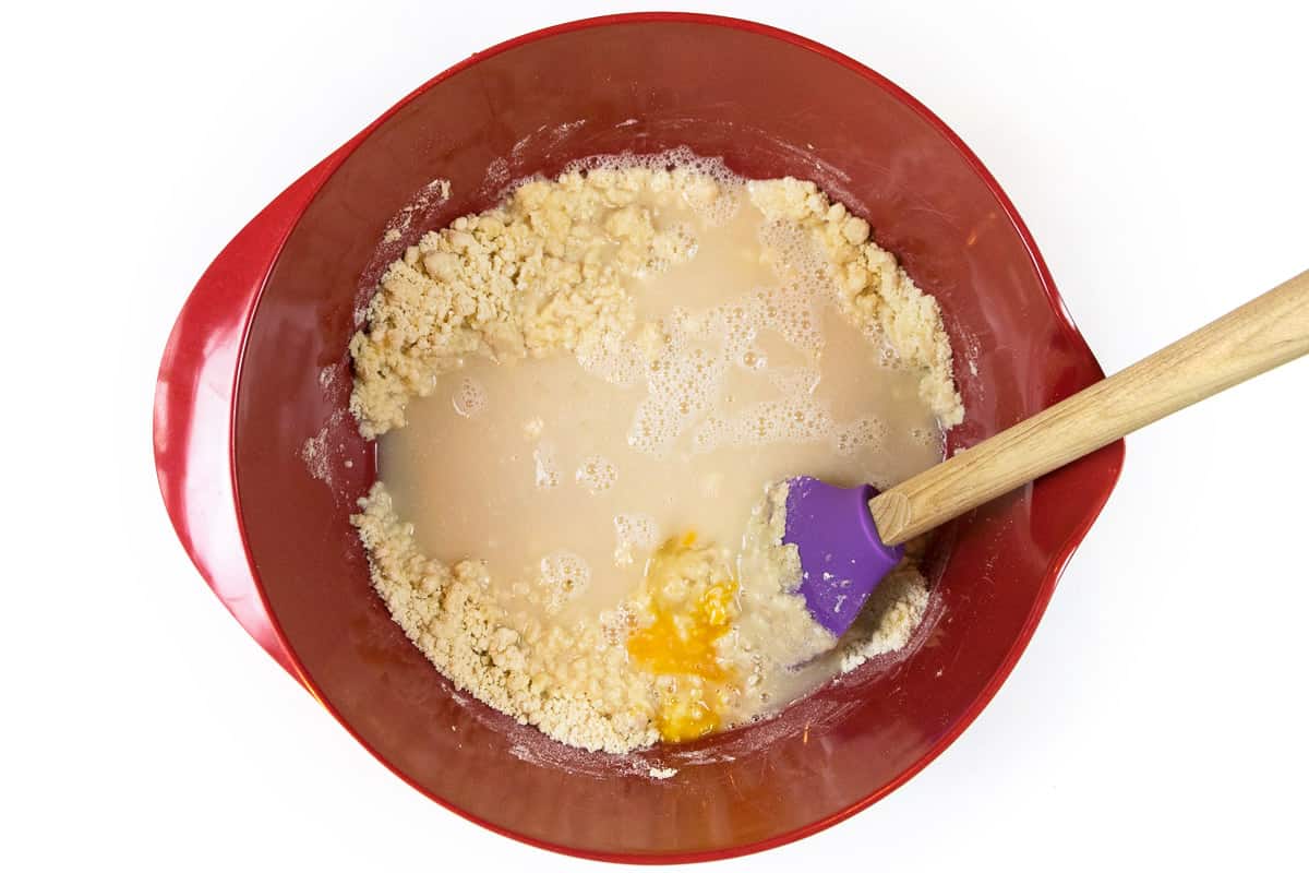 The yeast mixture and egg are immediately added to the crumbly mixture.
