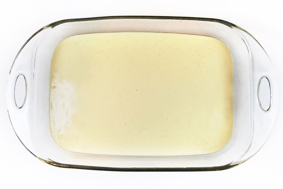 Greased baking dish filled with coffee cake batter.