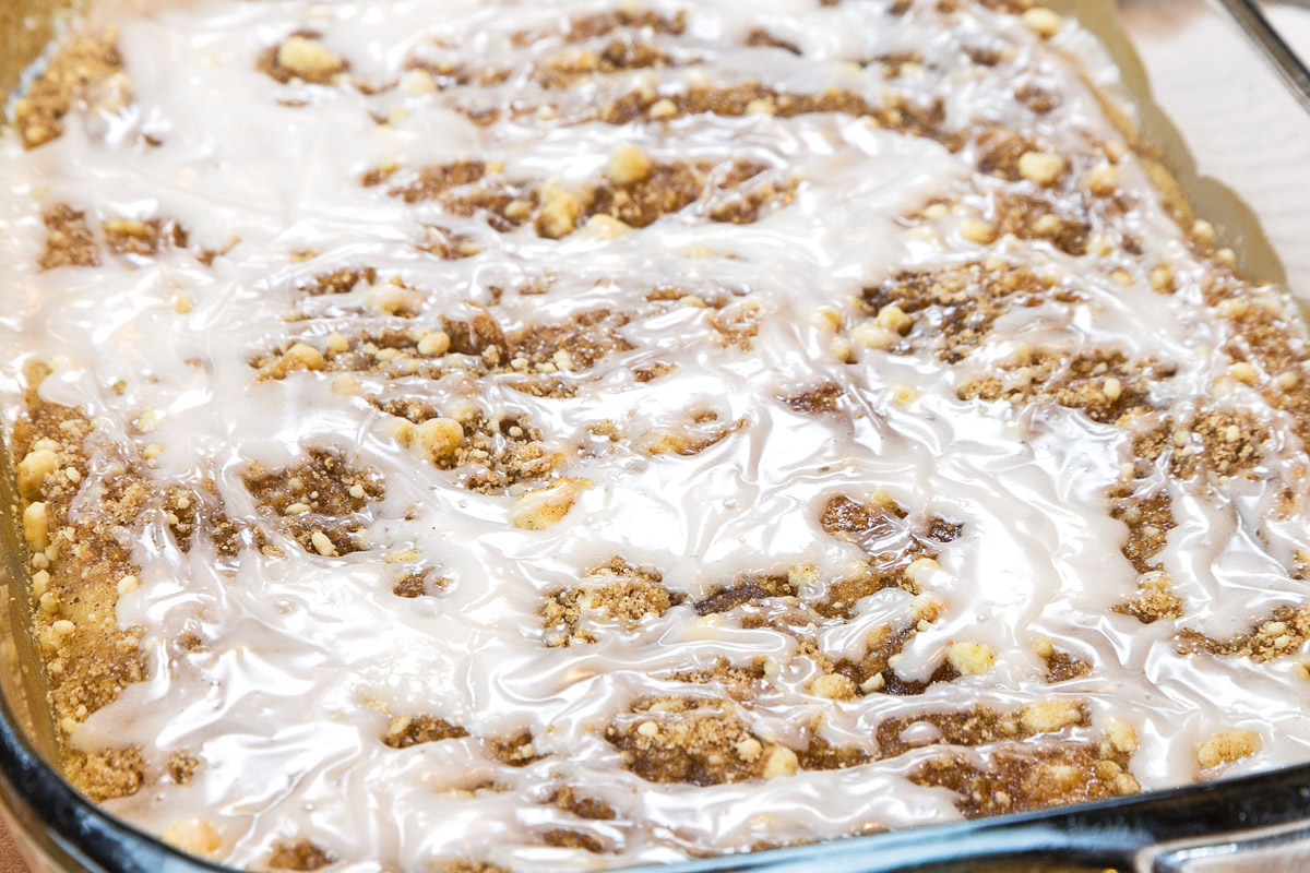 Icing on top of cherry coffee cake.