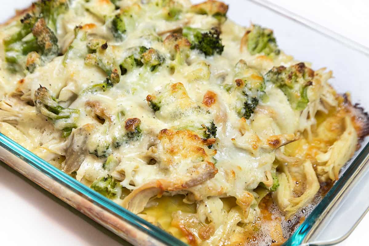 Baked chicken and broccoli lasagna in a casserole dish.