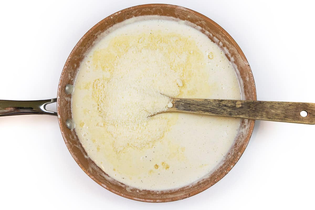 Add grated parmesan cheese to the heavy cream mixture.