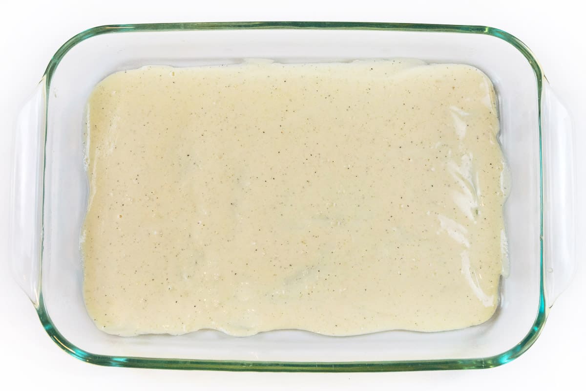 Spread a layer of alfredo sauce.