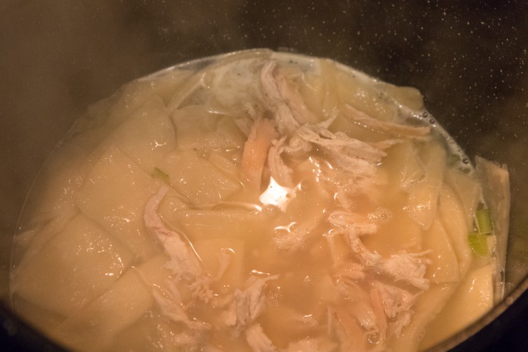 Add the shredded chicken together with the dumplings and chicken broth mixture.