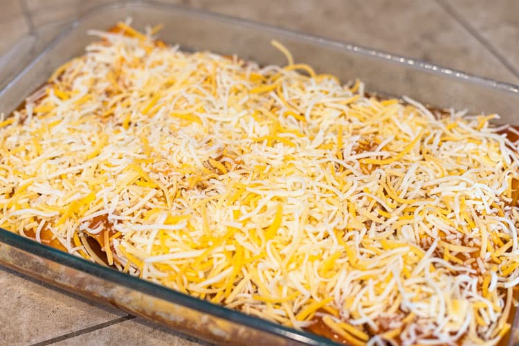 Add cheese on top of Chicken Enchiladas